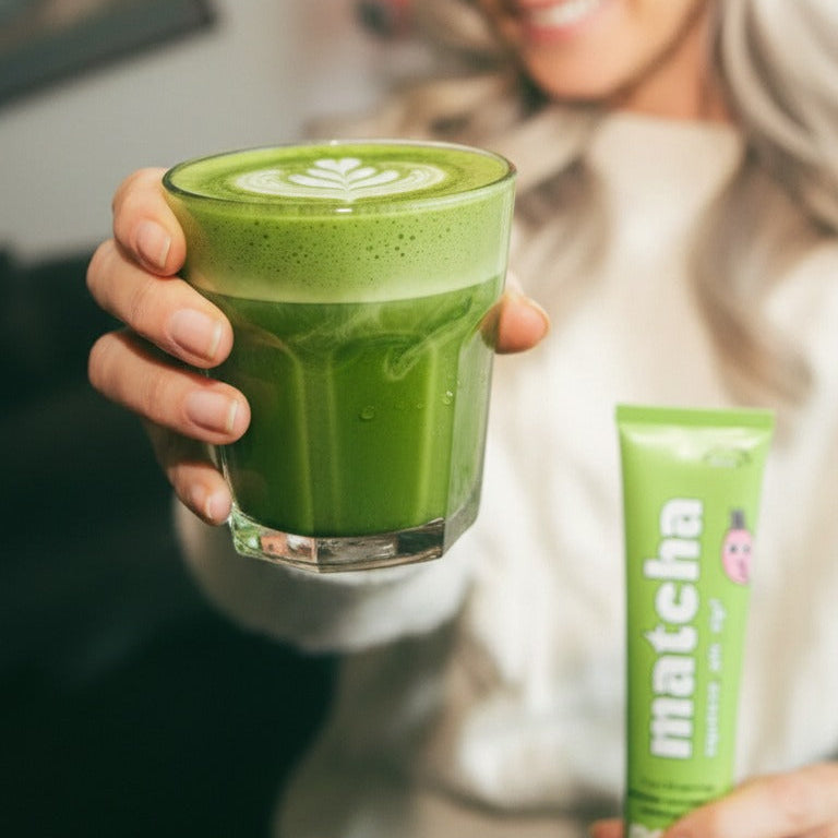Customer holding a Poda matcha latte with the matcha paste tube