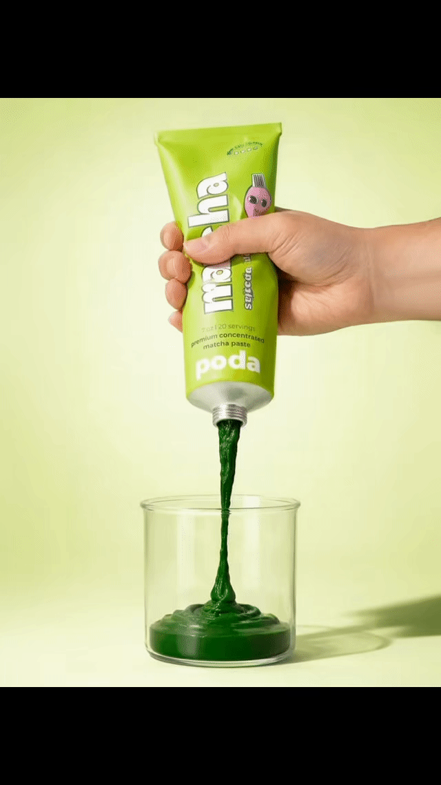 squeezing poda matcha paste into a cup